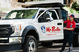 White Mr. Rooter truck arriving for sewer and drain service.