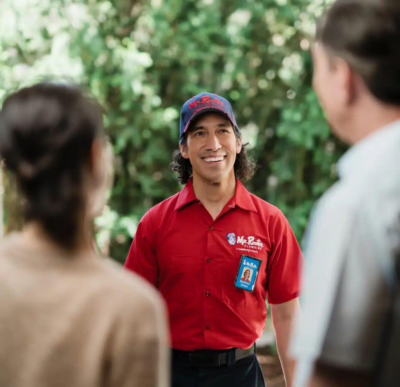A Mr. Rooter Plumber employee greeting hownowners in Miami