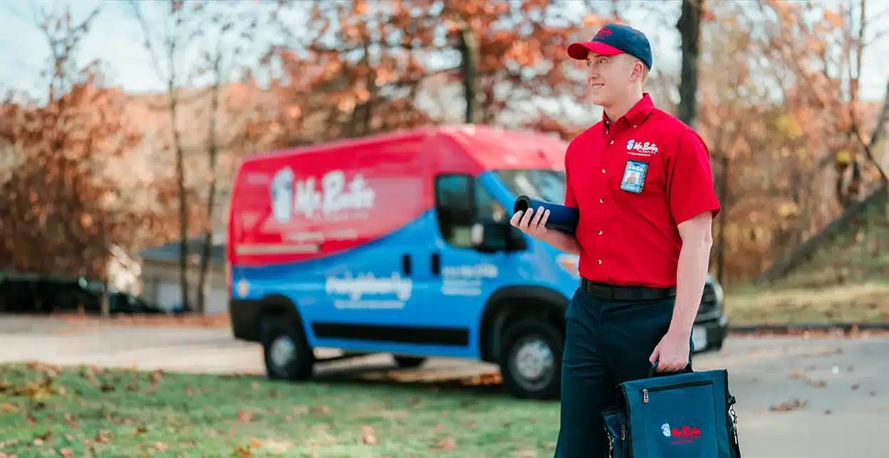 Mr. Rooter Plumbing employee in New Mexico outside of his work van