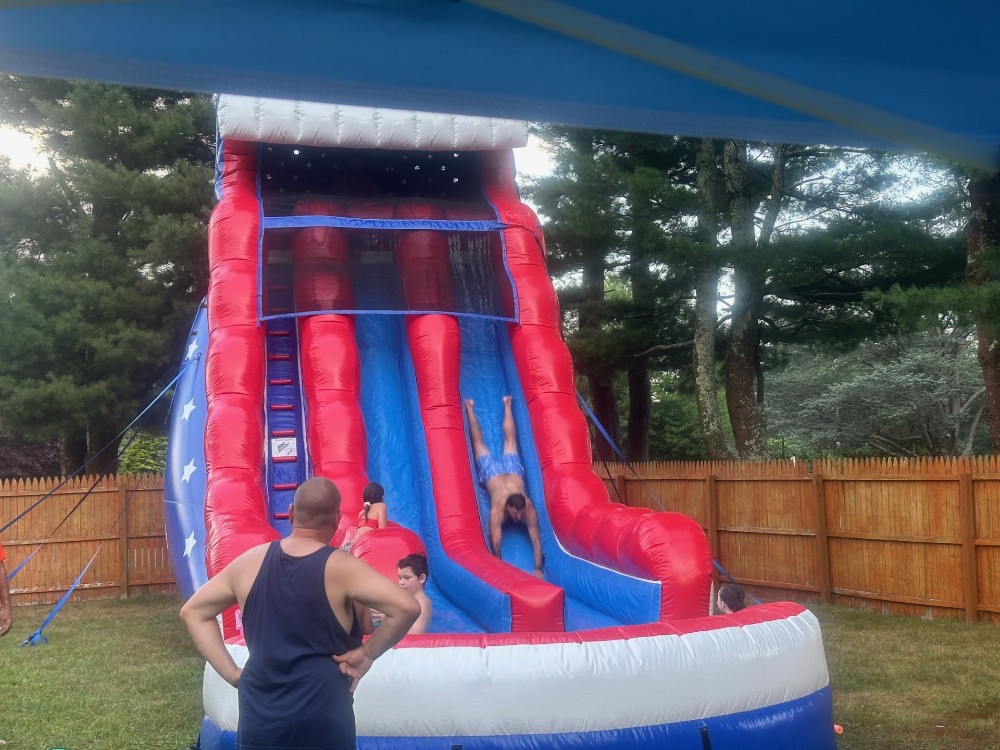 Even the grownups love the water slide fun at our employee appreciation party