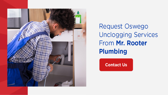  Mr. Rooter service technician installing residential plumbing together under the sink.