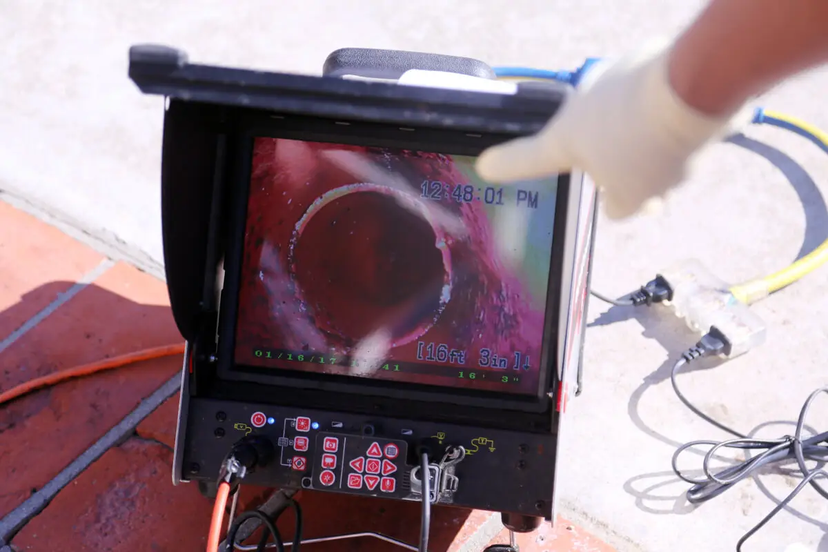 Mr. Rooter professional showing results of sewer camera inspection.