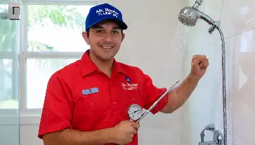 Mr. Rooter professional working on fixing water pressure in a shower.